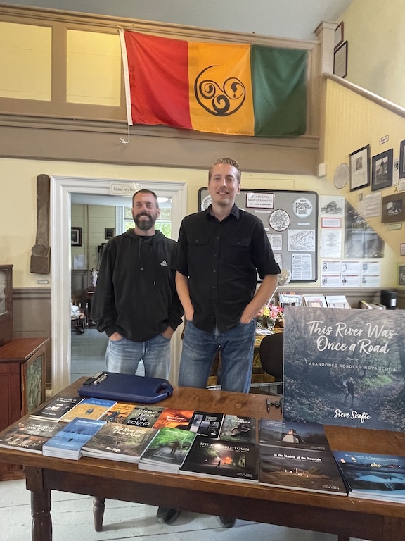 Presentation in Old Courthouse Museum showing a projected image on screen at left with Steve Skafte standing behind podium on the right.